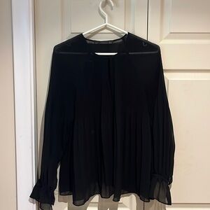 Black ruffled blouse. Flowy material and very breathable.